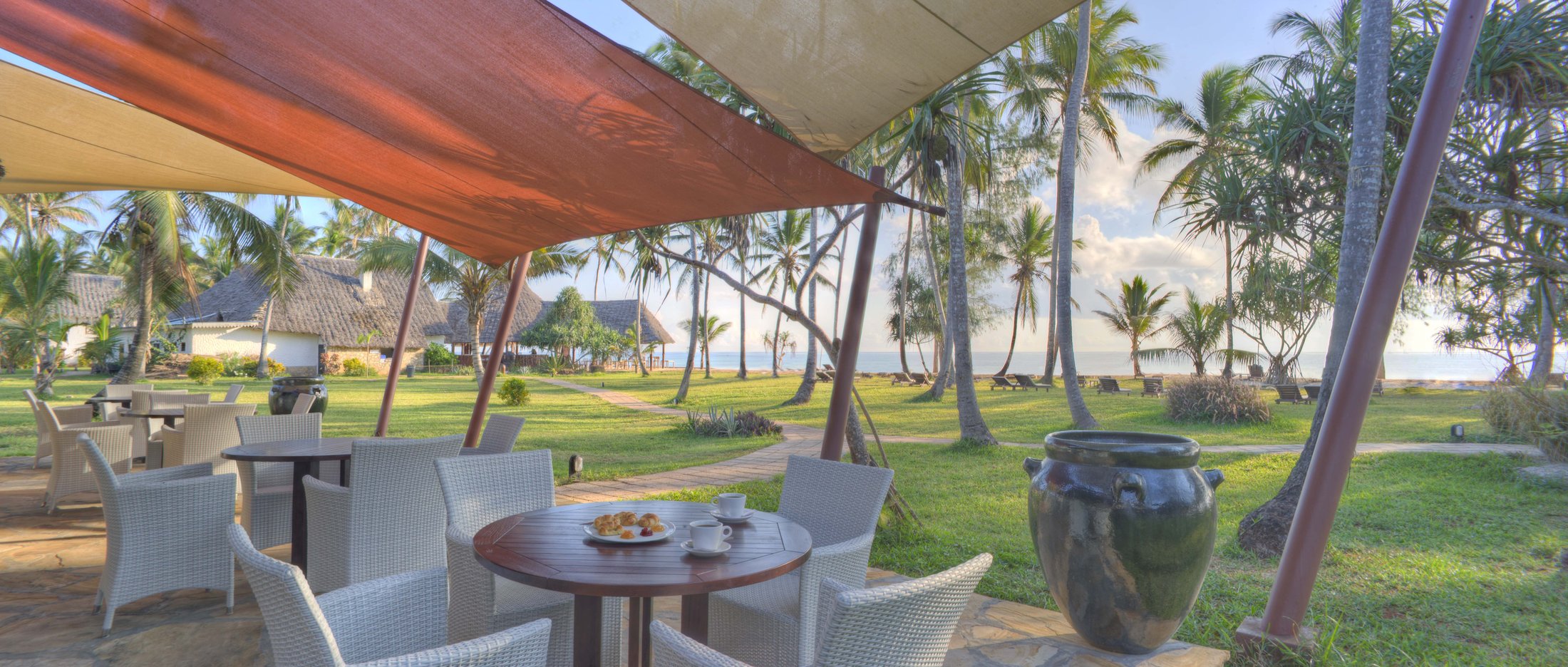 Sun loungers and palms on Bluebay's 582 m white-sand beach